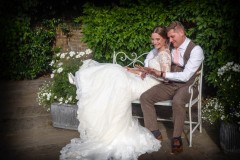 bride and groom looking a wedding rings Lincolnshire Wedding Photographer