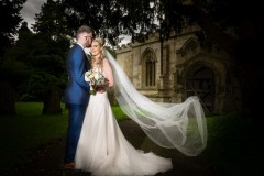 bride and groom veil shot