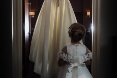 bridesmaid looking at wedding dress