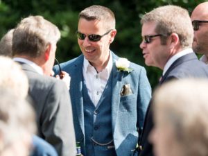 group of men talking at wedding