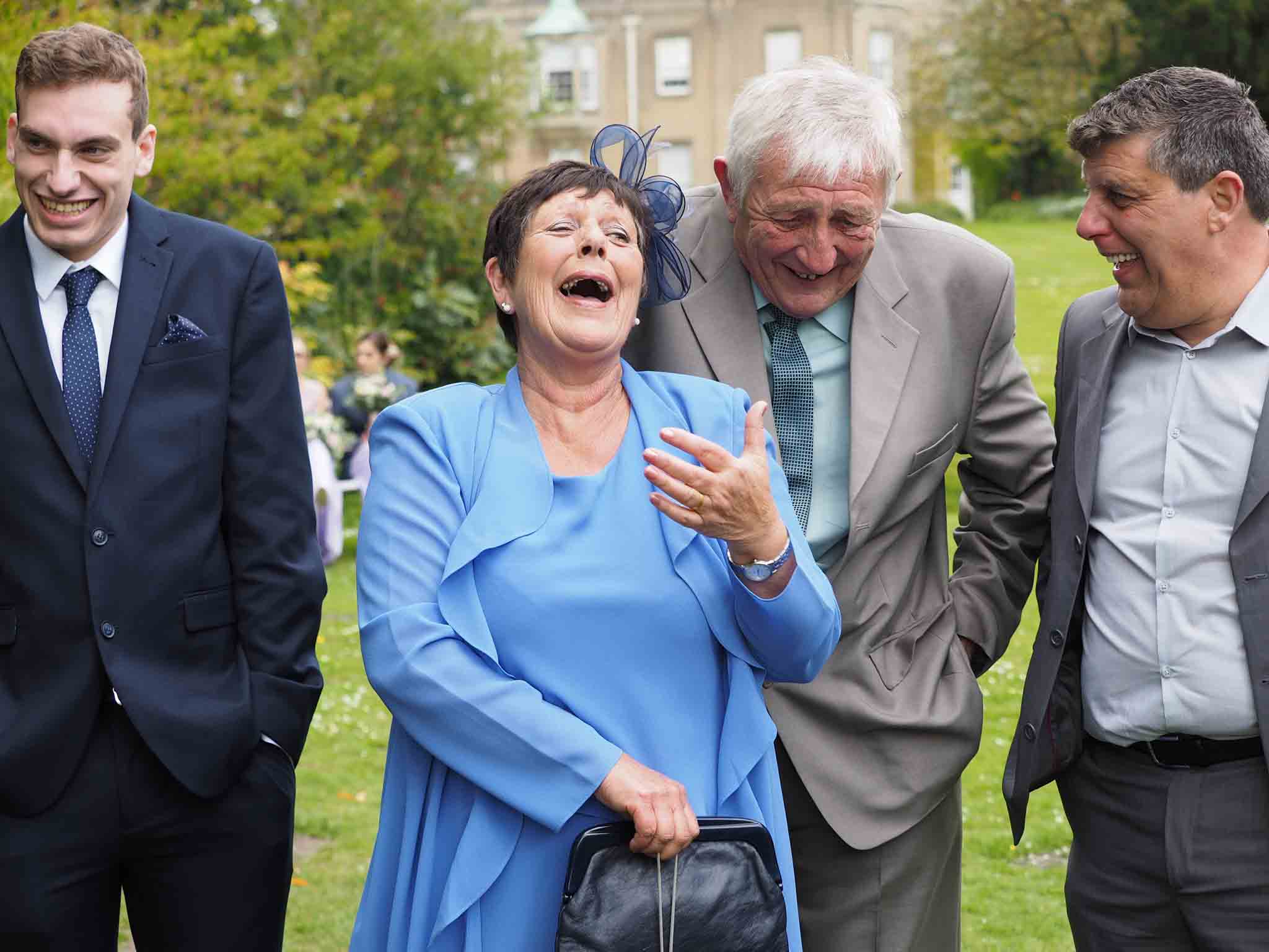 Group of wedding guests laughing